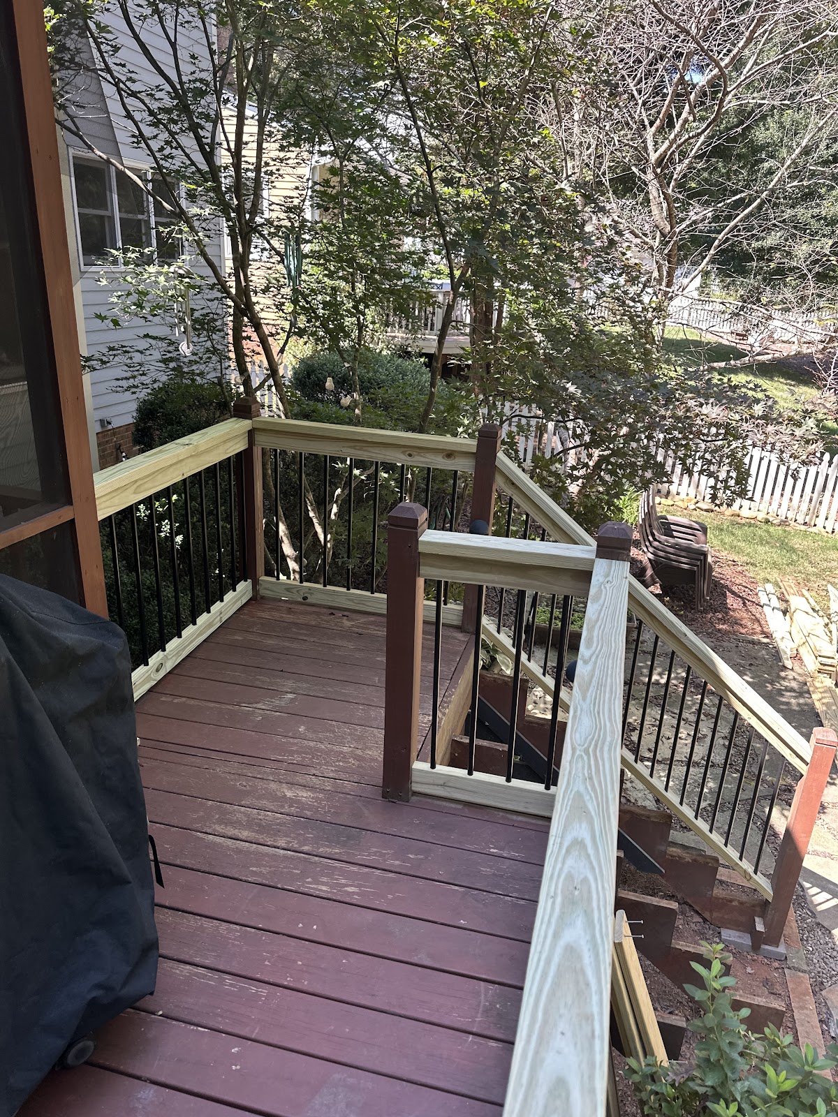Deck with new wooden railings and metal balusters